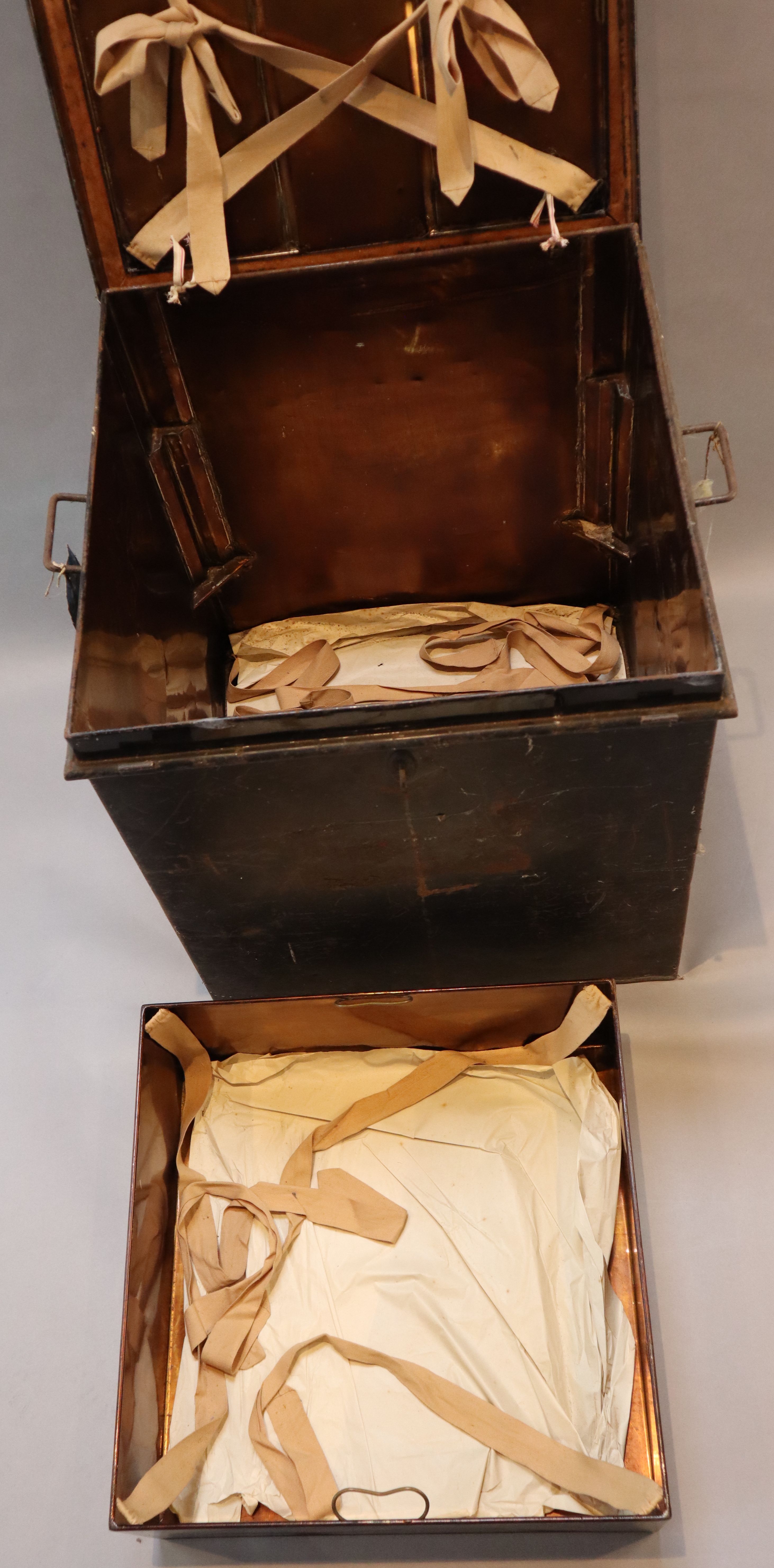 An early 20th century black painted tin travelling trunk, inscribed Lady Brabourne with old British India and Cooks Travel labels, wi